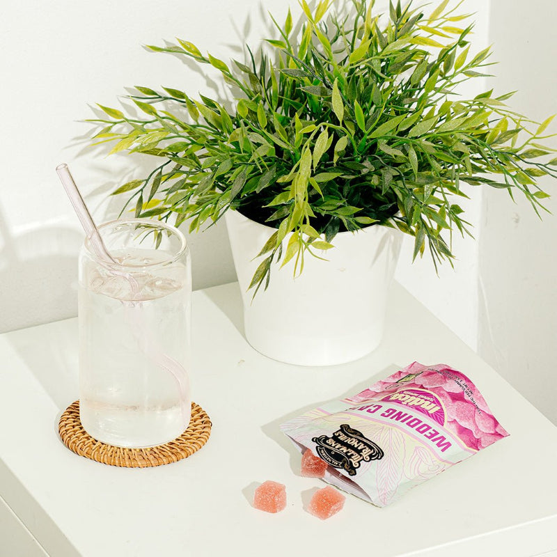 Potted plant, glass with straw, and wedding cake gummies
